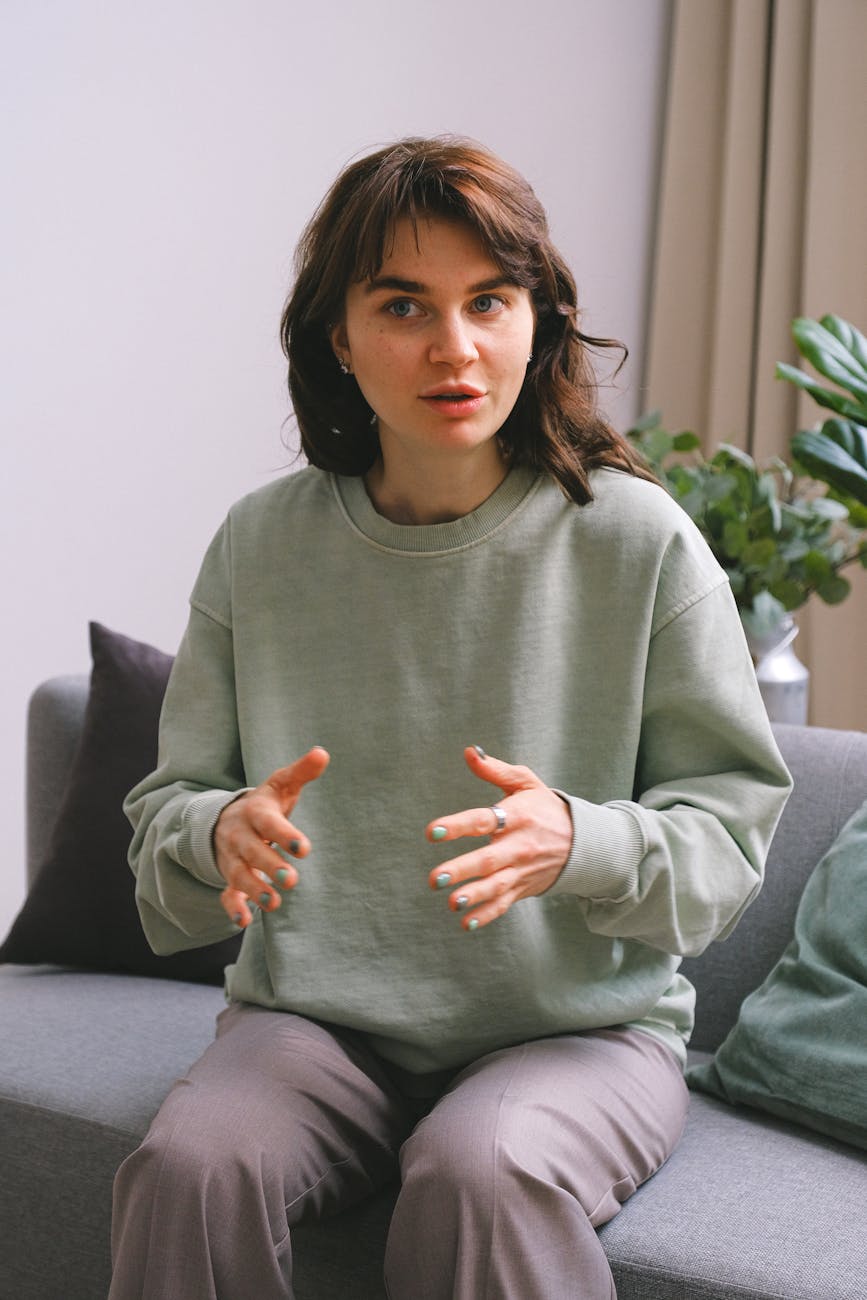 woman on sofa in therapy office sharing problems